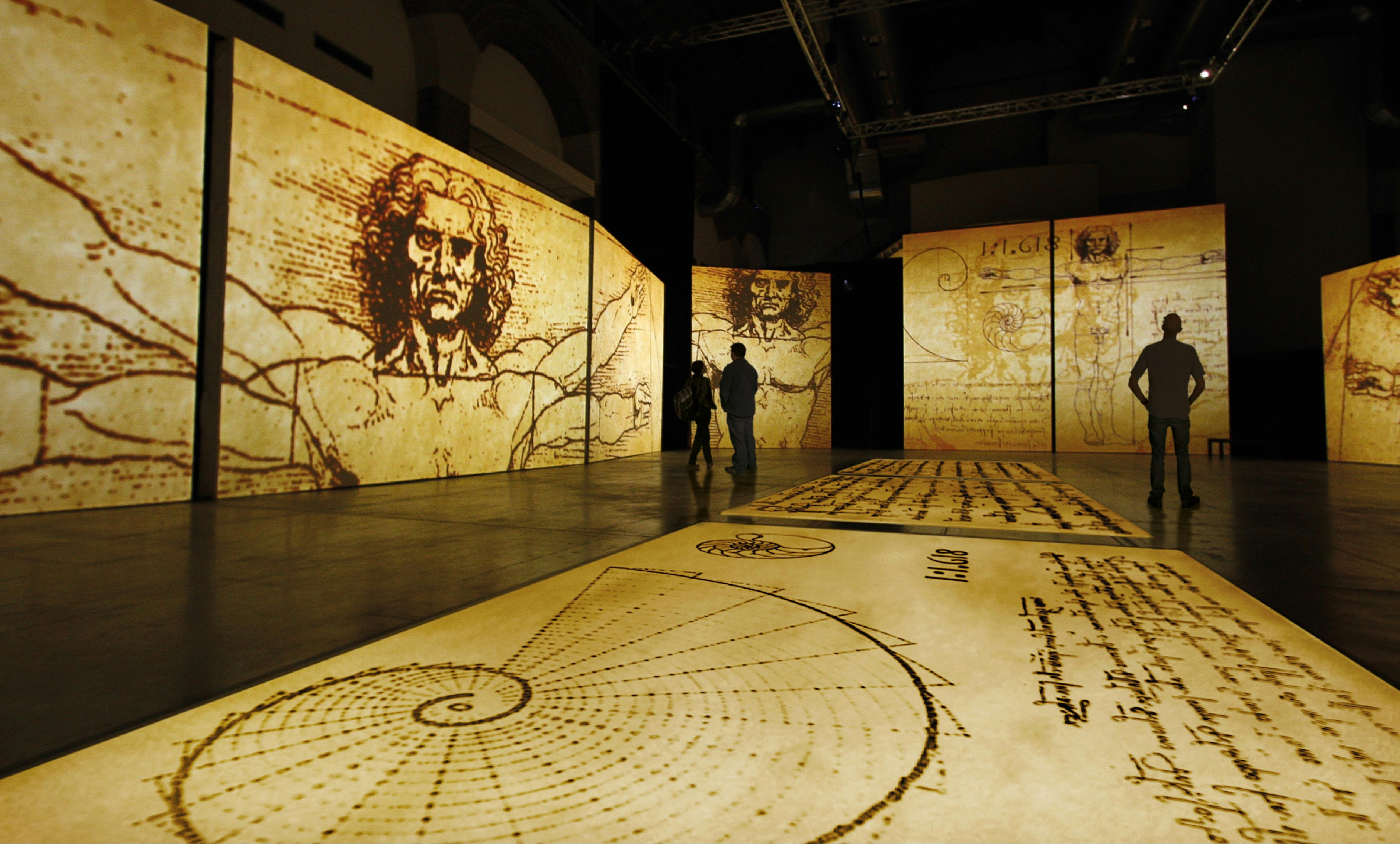 Visitors explore towering projections of Leonardo da Vinci’s sketches in an immersive gallery space.