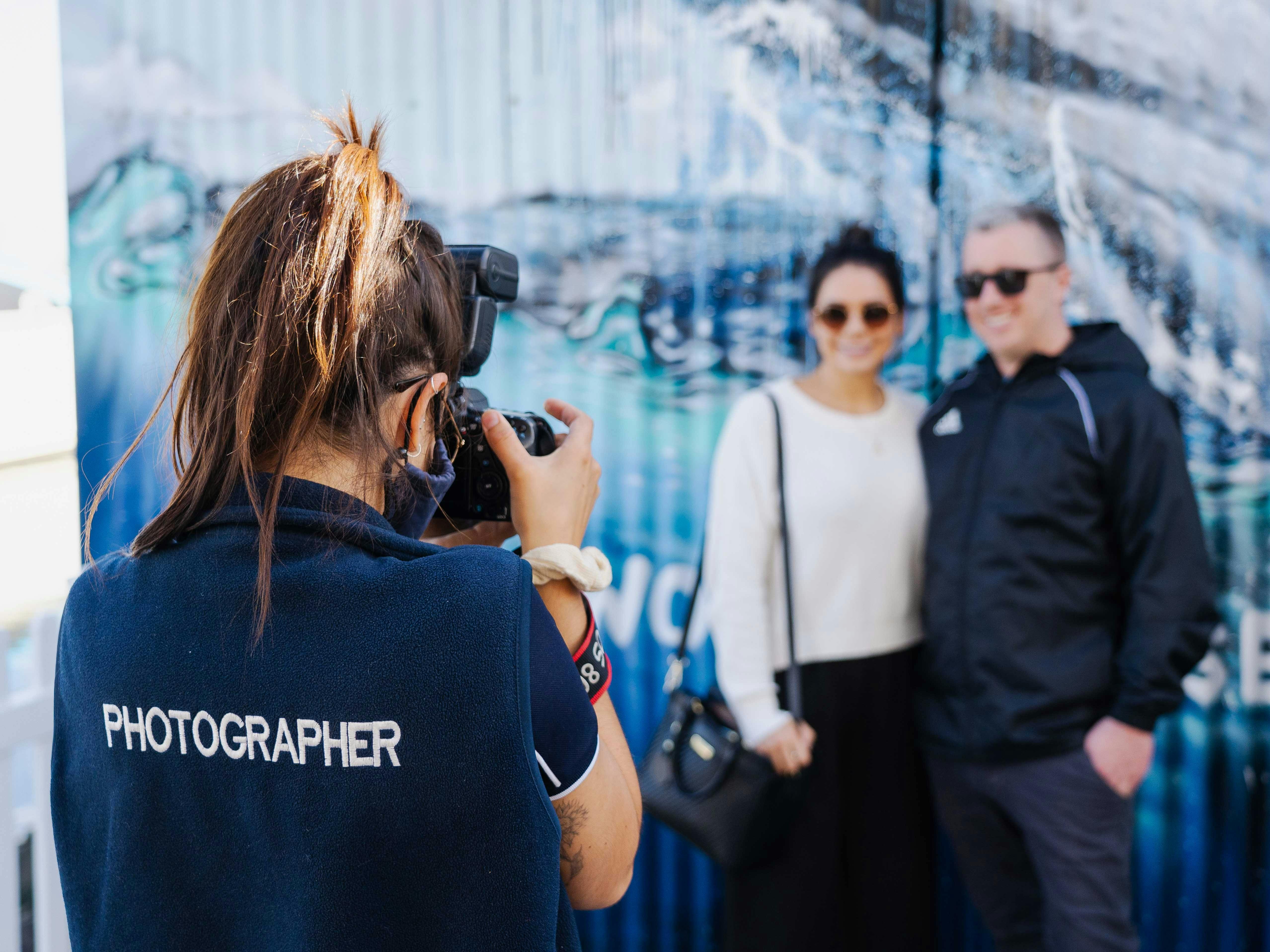Photographer taking photo of couple