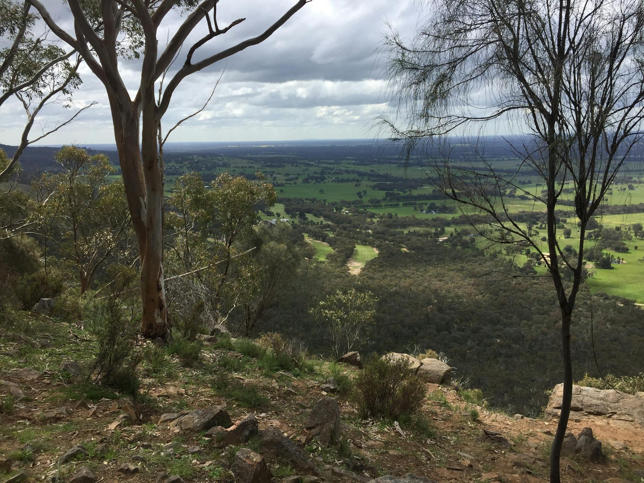 Lookout towards Ovens Valley, bush, trees, rocks, golf course, farm countryside, distant hills