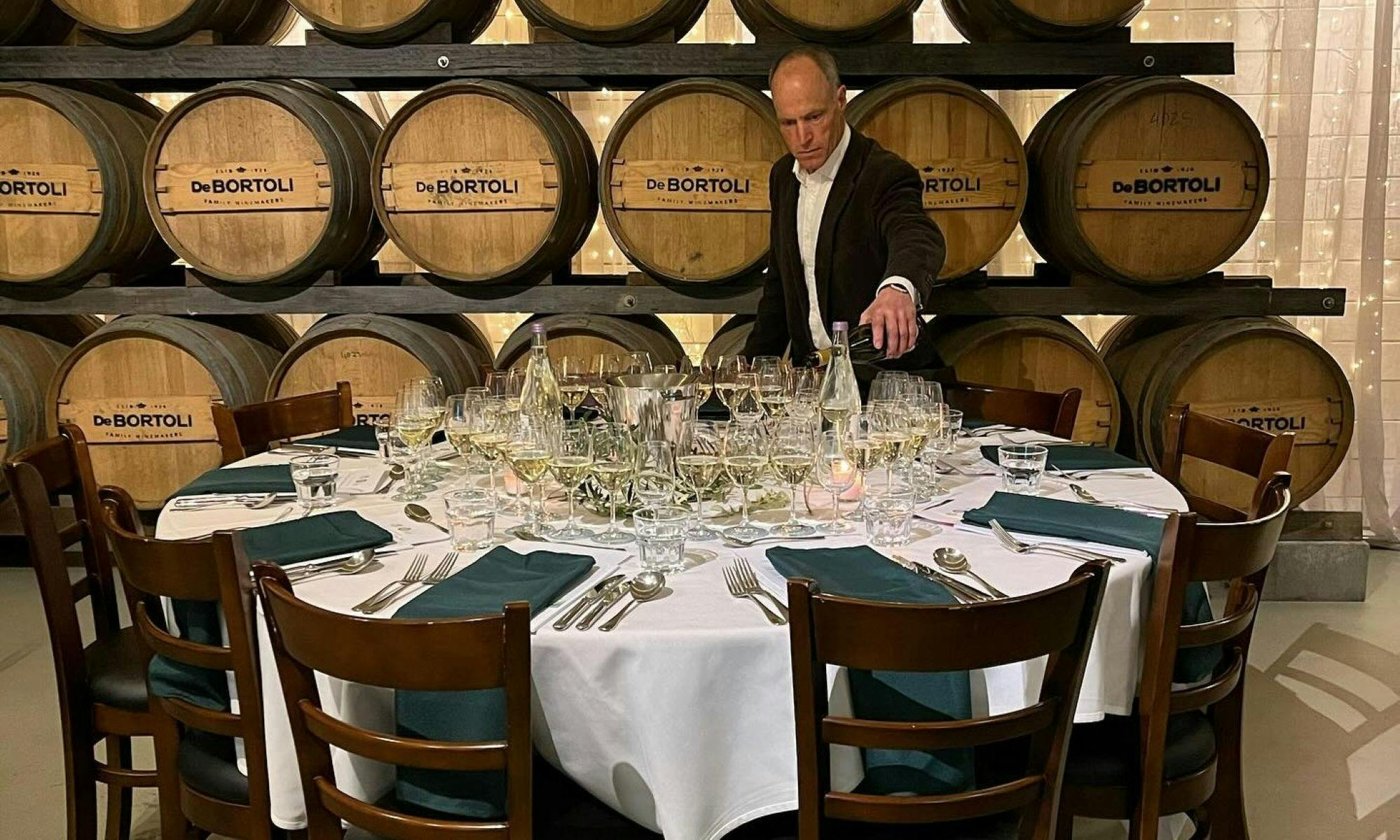 Filling glasses on a beautifully set table.