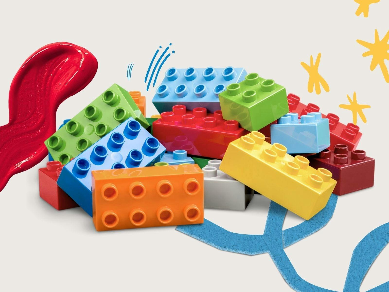 Pile of colourful Lego bricks and splashes of paint
