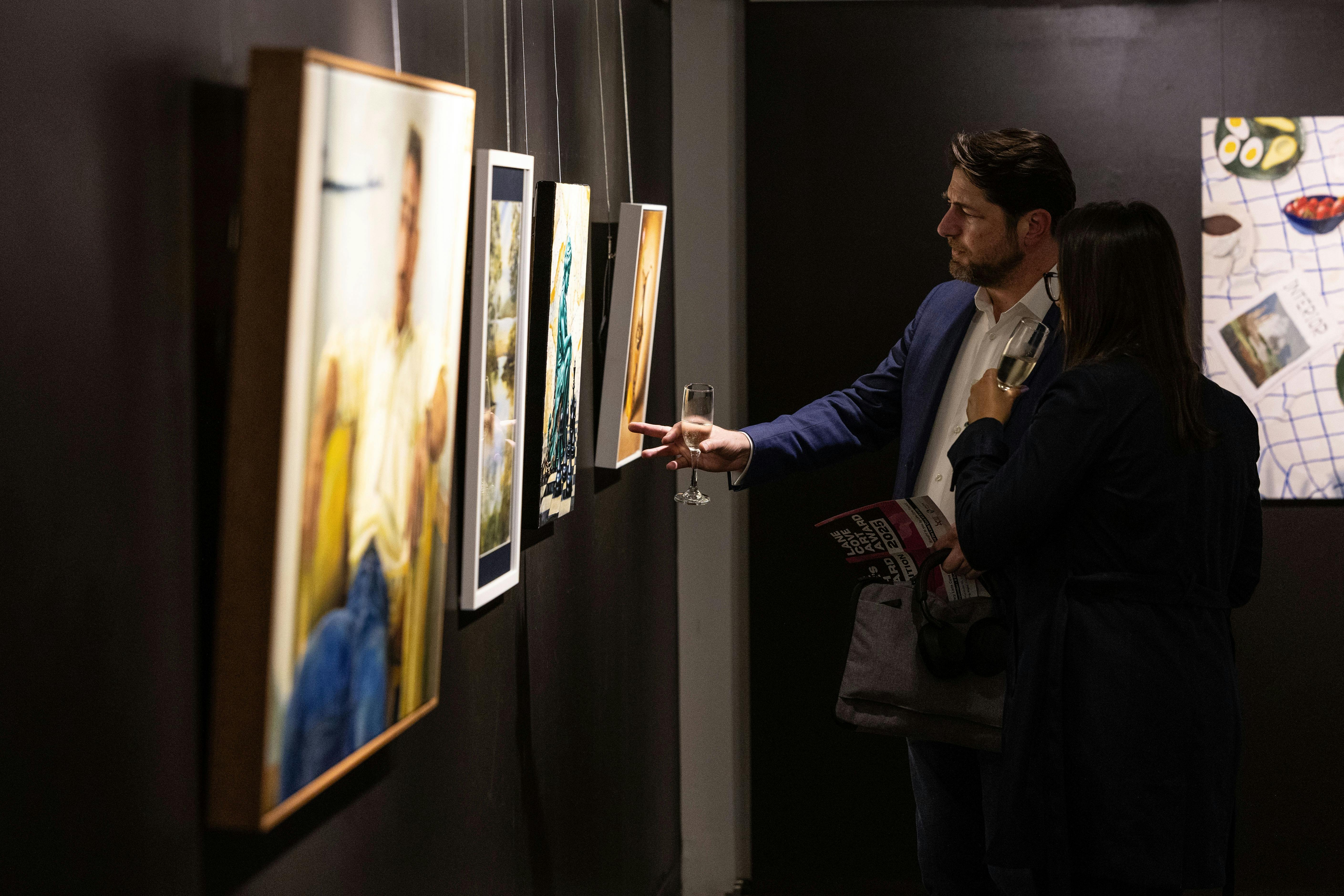 Two people looking at art work