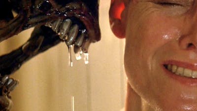 Woman looking scared on right with alien figure with dripping teeth threatening her