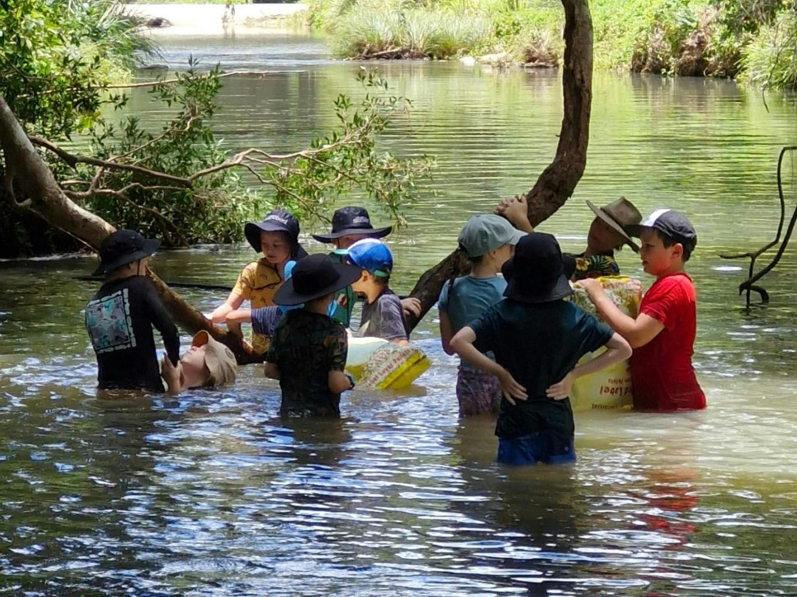 Children wading in creek at Birdwings Forest School Kids Holiday Nature Adventures Gold Coast Hinter