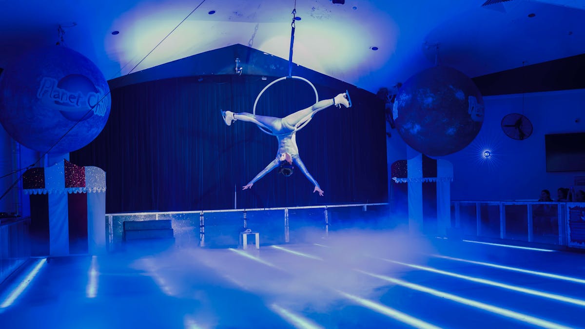 Aerialist performing above the ice rink Aerialist performing above the ice rink