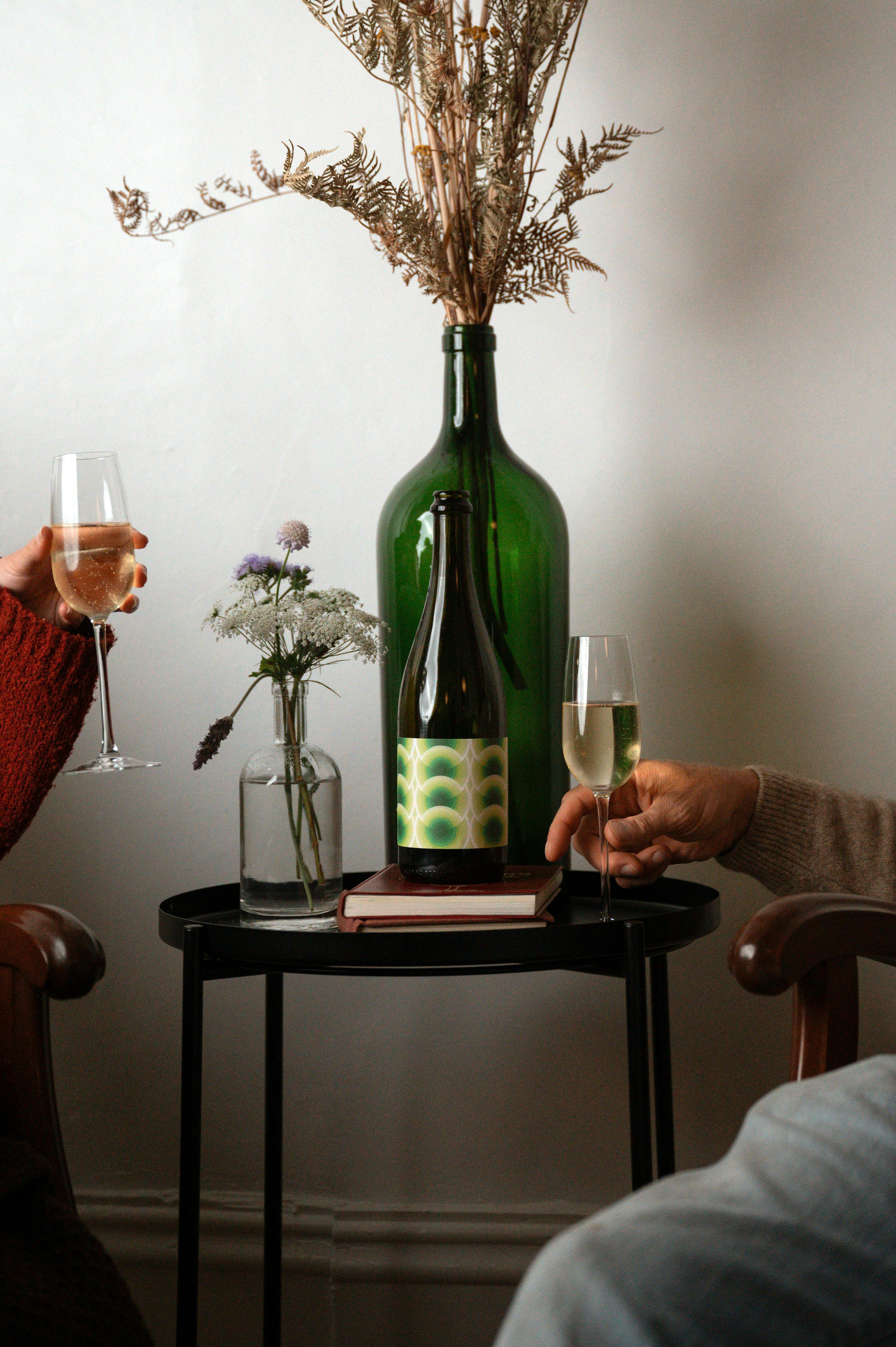 two hands with glasses of wine