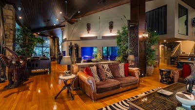 Lounge room surrounded by 200,000L aquarium. African inspired styling.