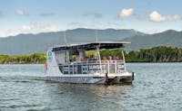 River Cruise Boat with a group relaxing and taking in the site of Tropical North Queensland