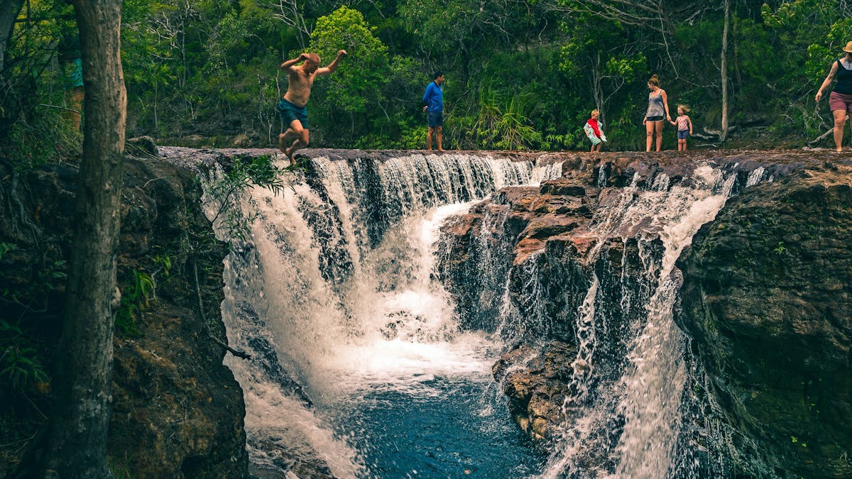 Group of people swimming and jumping at Eliot Falls (not Elliot falls!) in Jardine National Park.