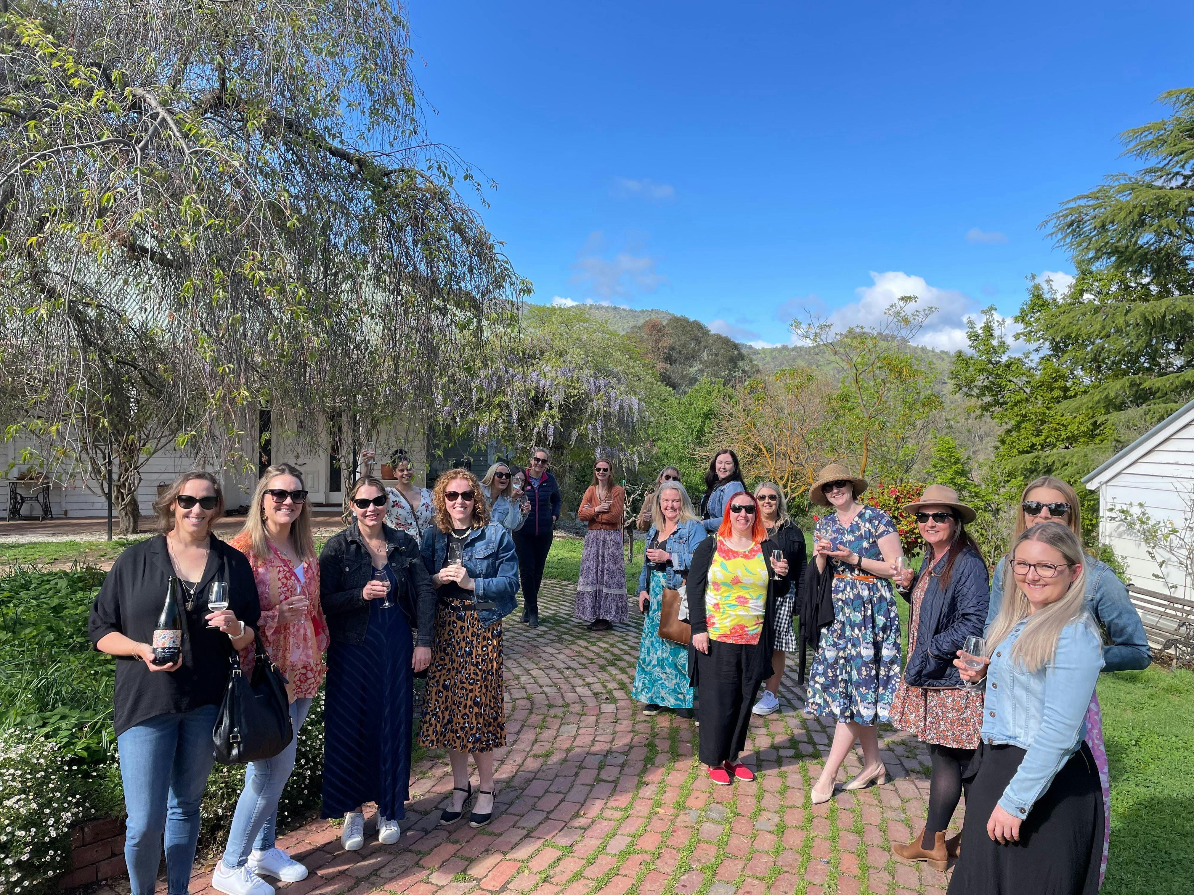 Large  group of ladies enjoying a tasting in the beautiful gardens at Brave Goose Vineyard