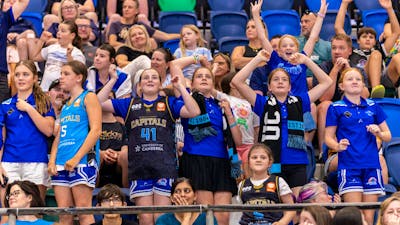 UC Capitals fans cheering in the stands.