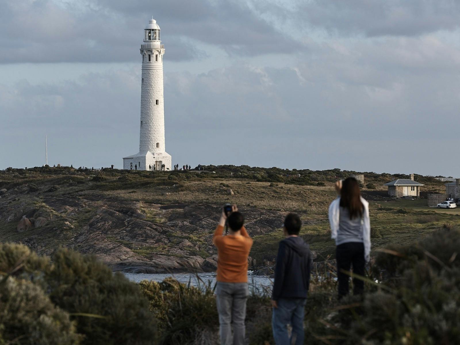 Distant view of Cape Leeuwin Lighthouse overlooking the rugged coastline