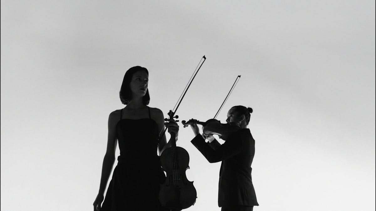 Elizabeth Lawrence holding Viola and Jason Tong holding Violin Elizabeth Lawrence holding Viola and Jason Tong holding Violin