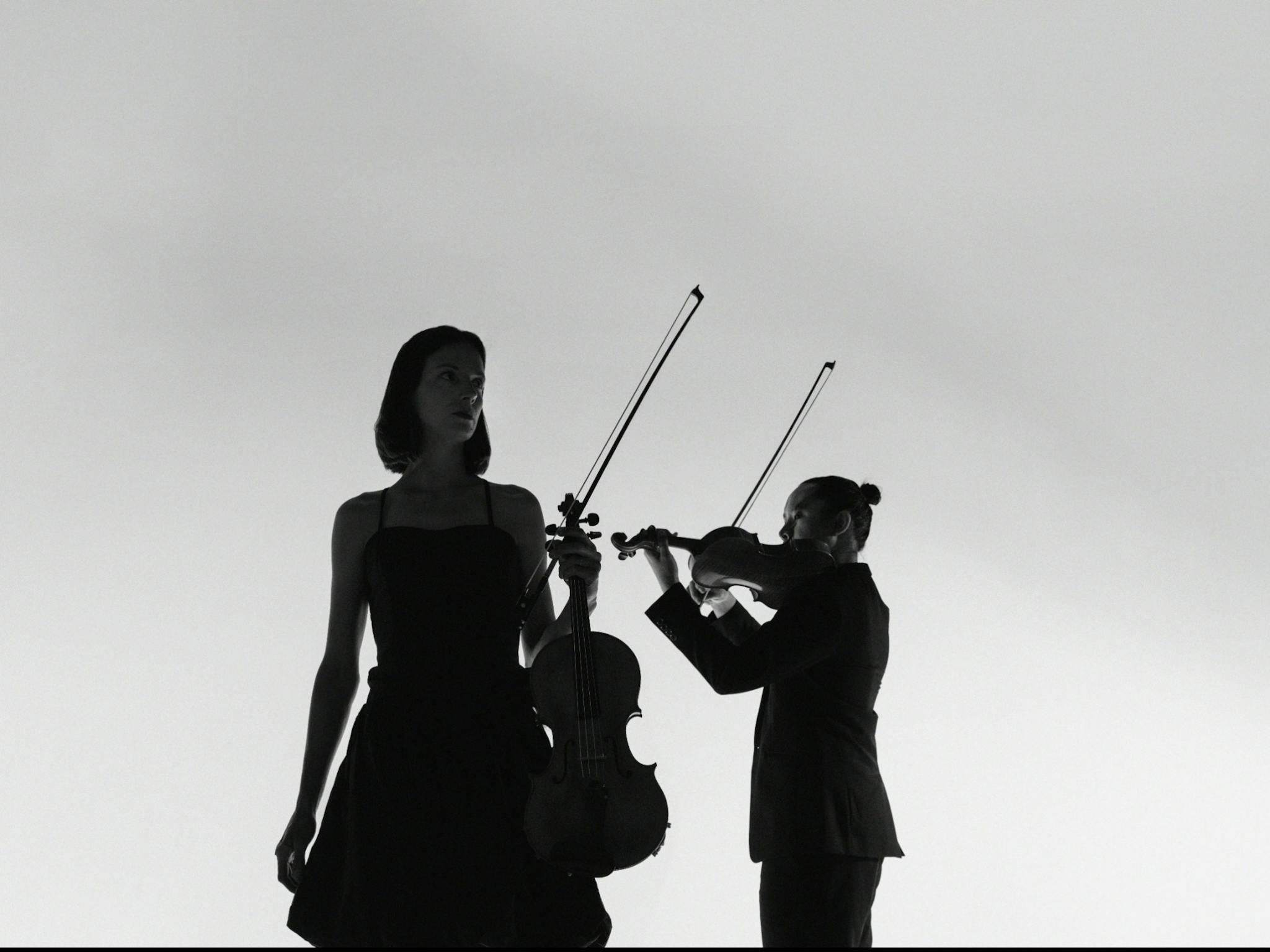 Elizabeth Lawrence holding Viola and Jason Tong holding Violin Elizabeth Lawrence holding Viola and Jason Tong holding Violin