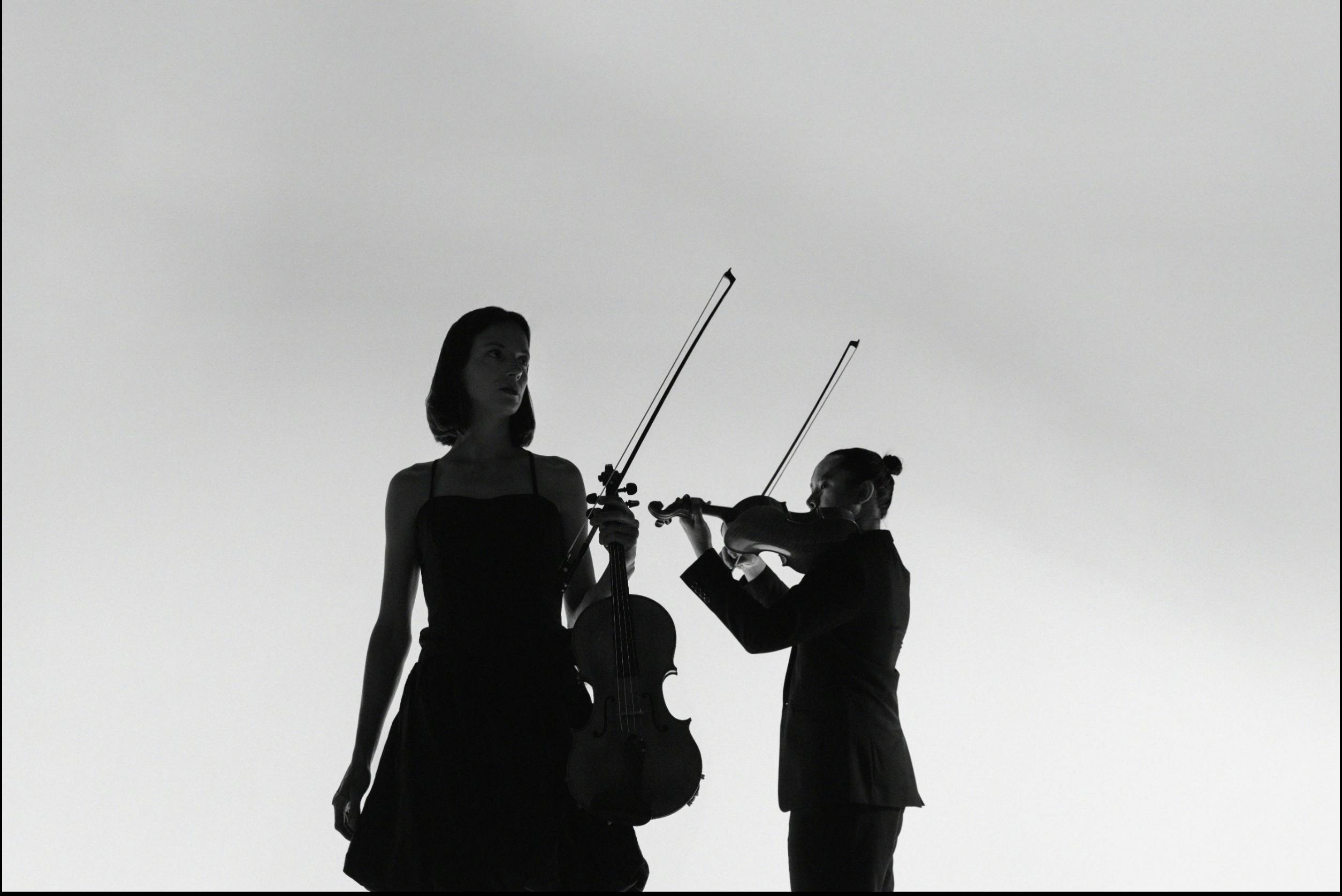 Elizabeth Lawrence holding Viola and Jason Tong holding Violin
