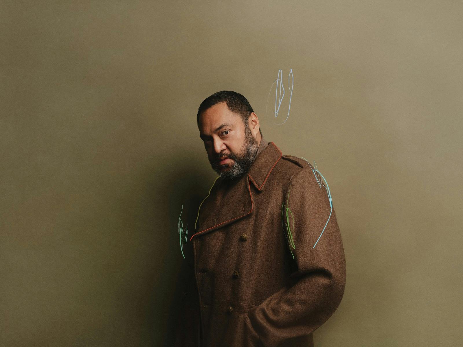 Macbeth wearing his army coat staring down the audience