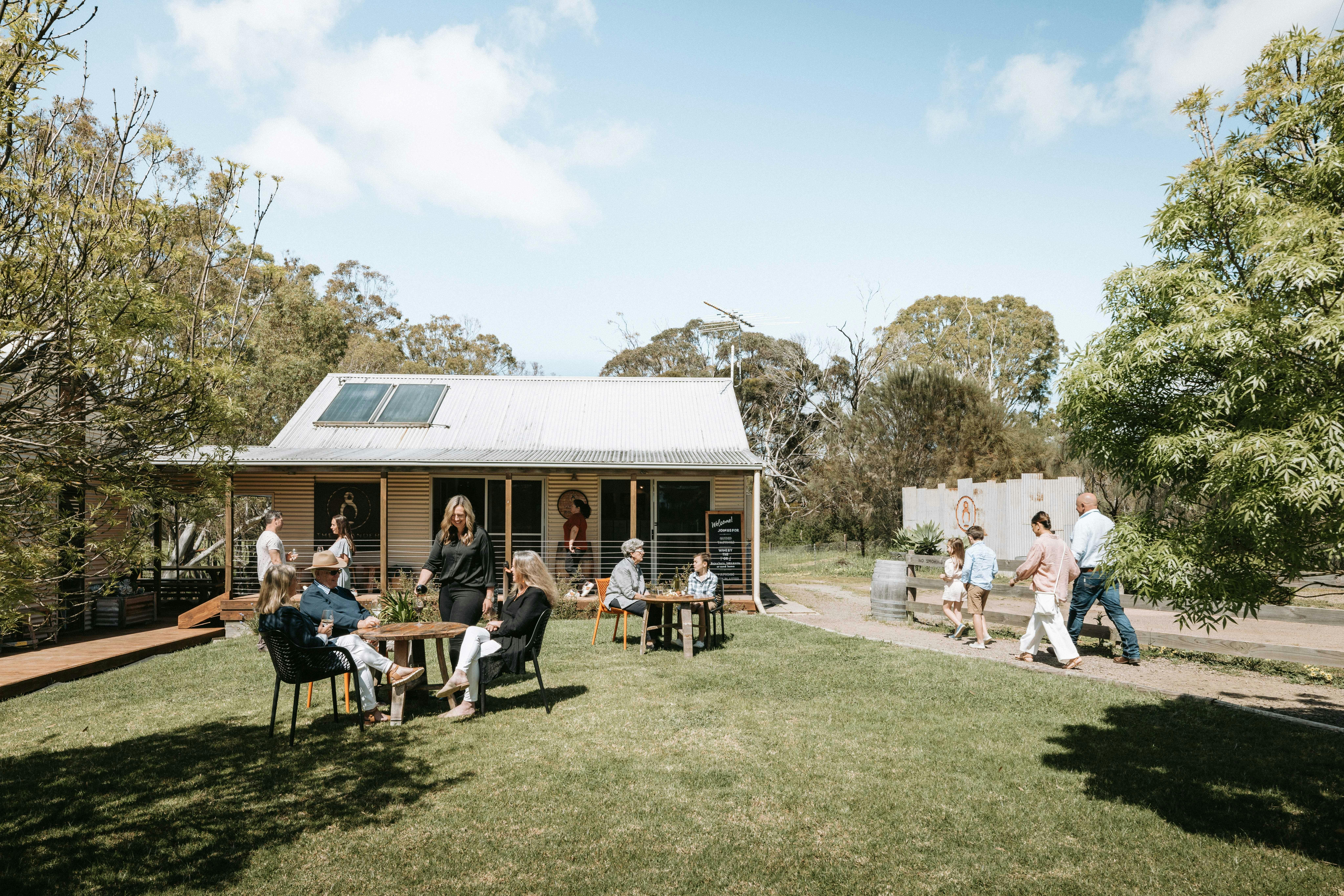 Picture of people in front of The Islander Estate Vineyards tasting room