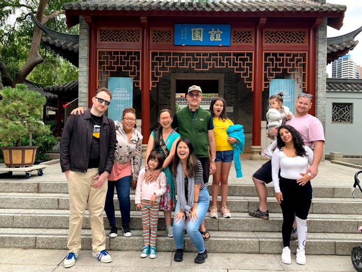Teams of family in front of a Chinese garden gate