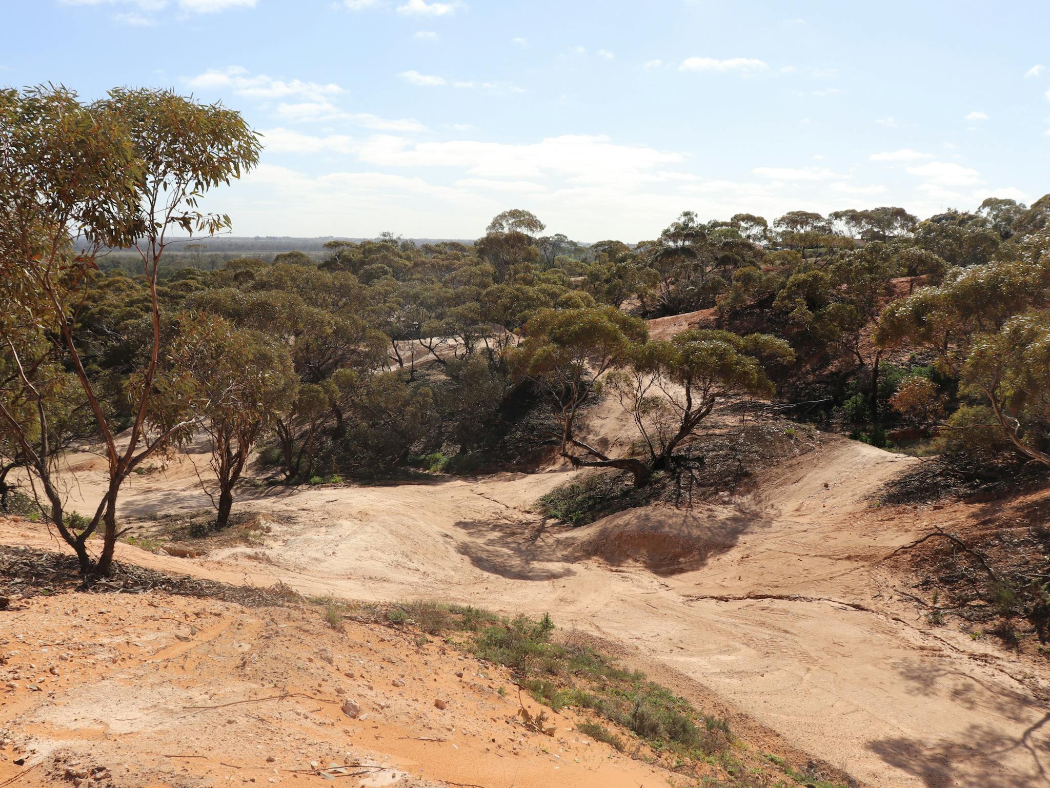 The track weaves through scrubland above the town's caravan park.