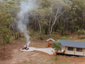 Aerial photo of tent, BBQ hut and firepit