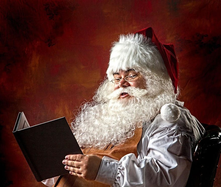 photo of santa reading a book