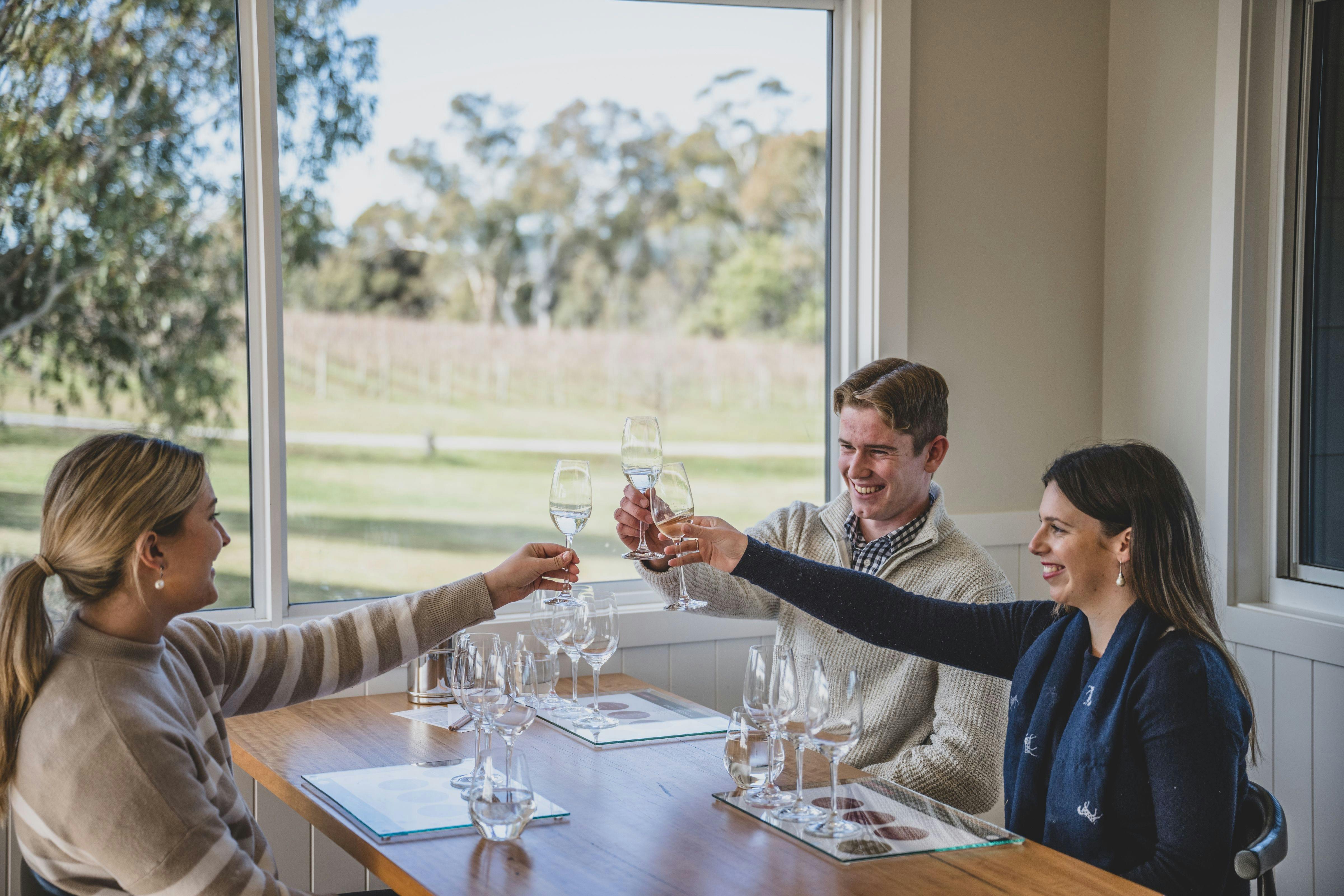 Three guests enjoying a taste experience at Swinging Bridge’s Cellar Door.