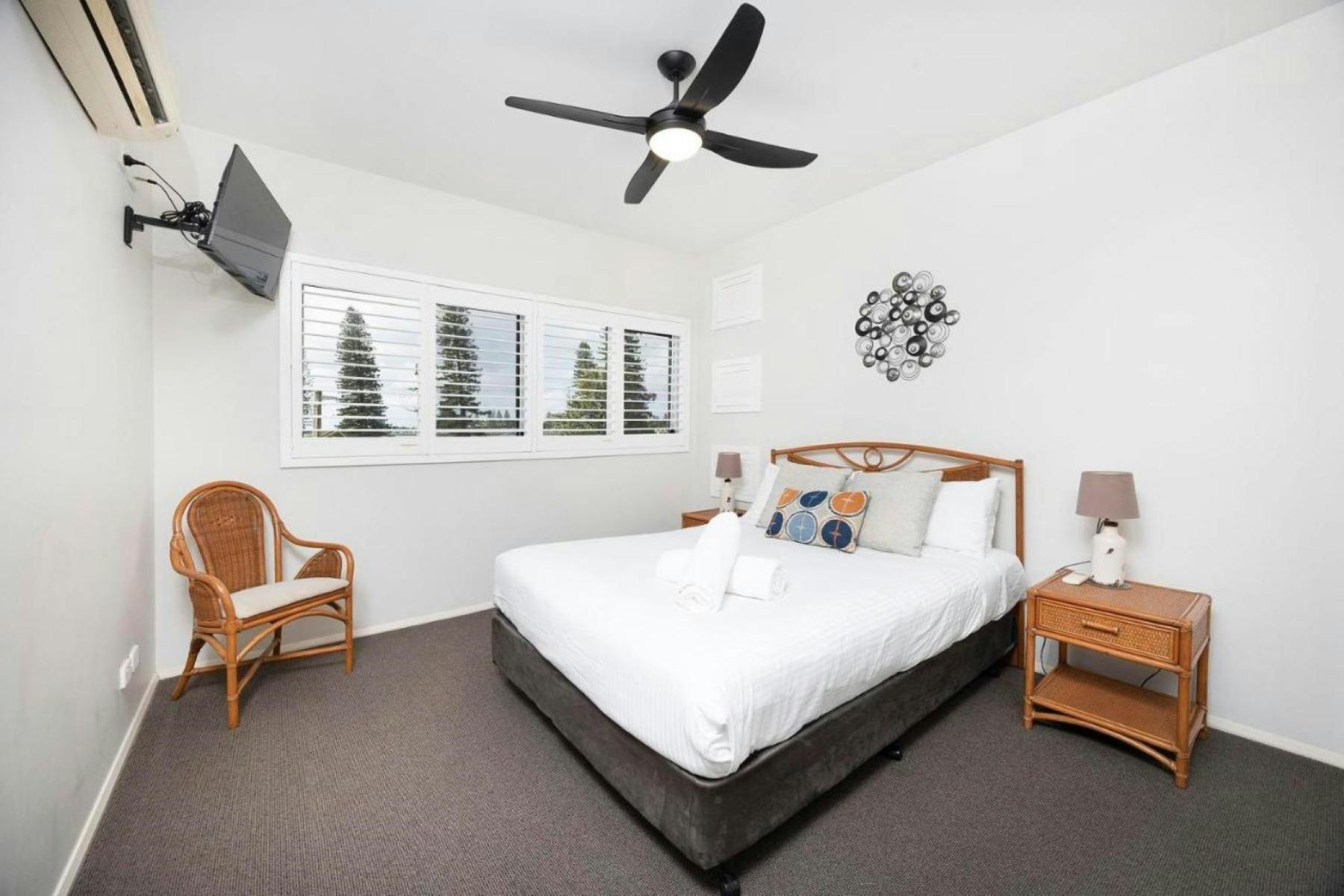 Master bedroom with TV, air-conditioning and ceiling fan