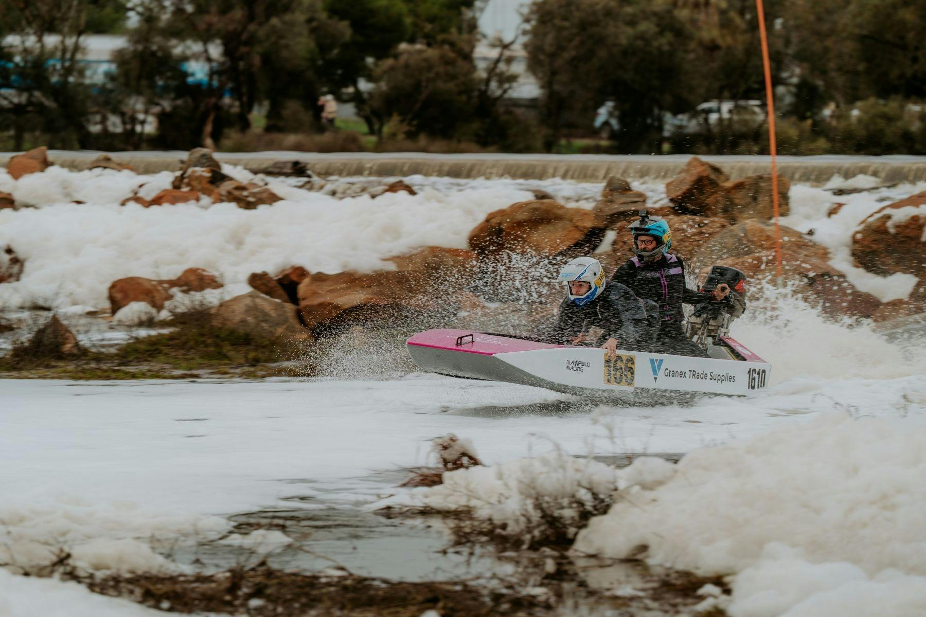 Power dinghy with two competitors in white water