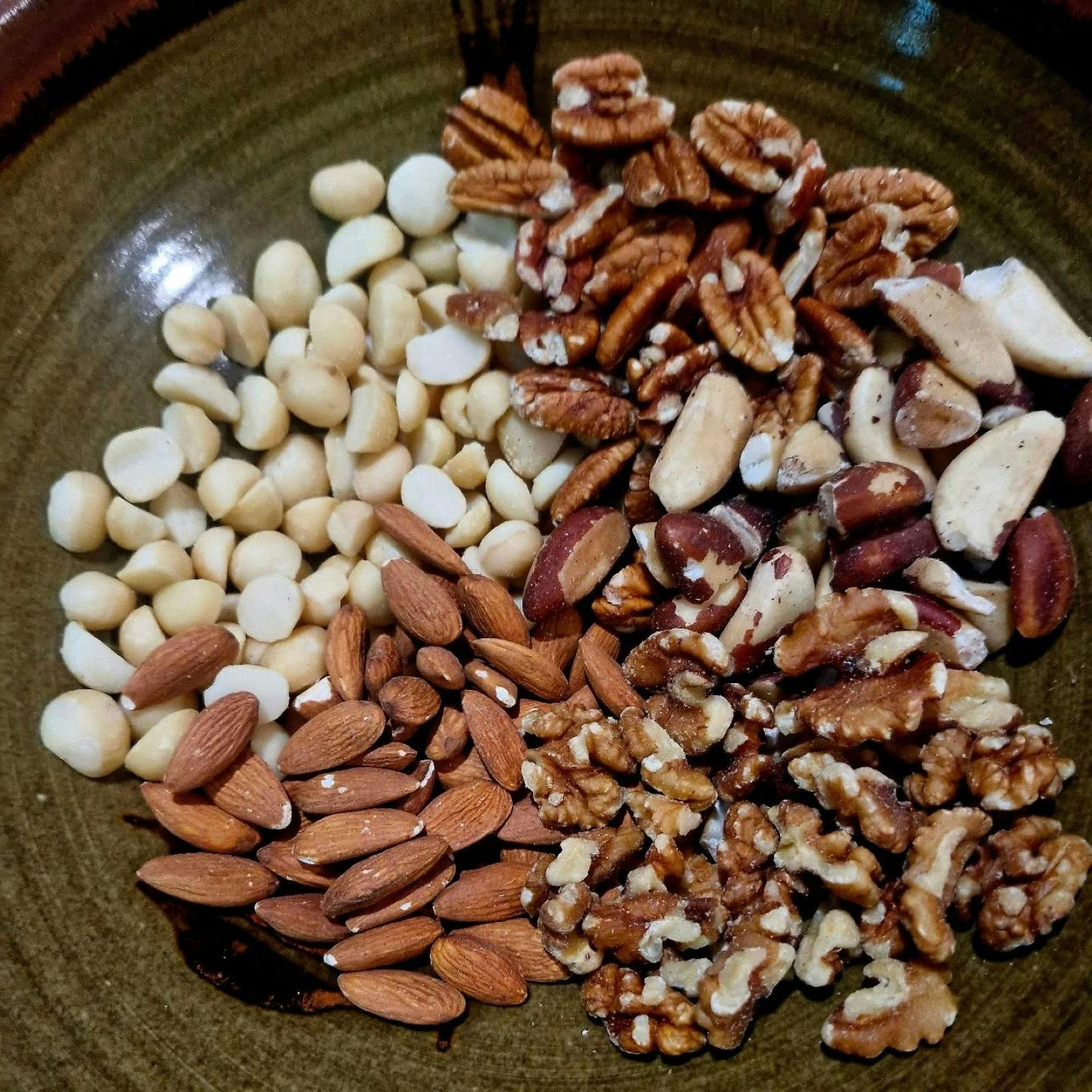 mixed nuts for the waffles in a green bowl