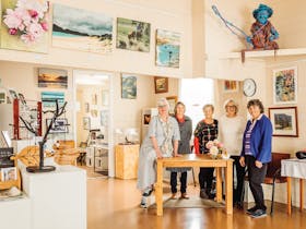 A group of women standing in an art gallery