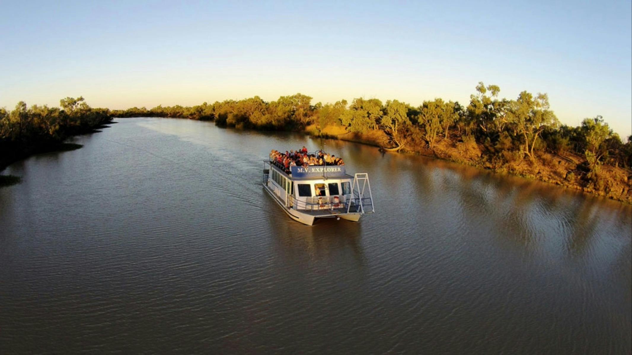 a blue and white catamaran in the middle of the river