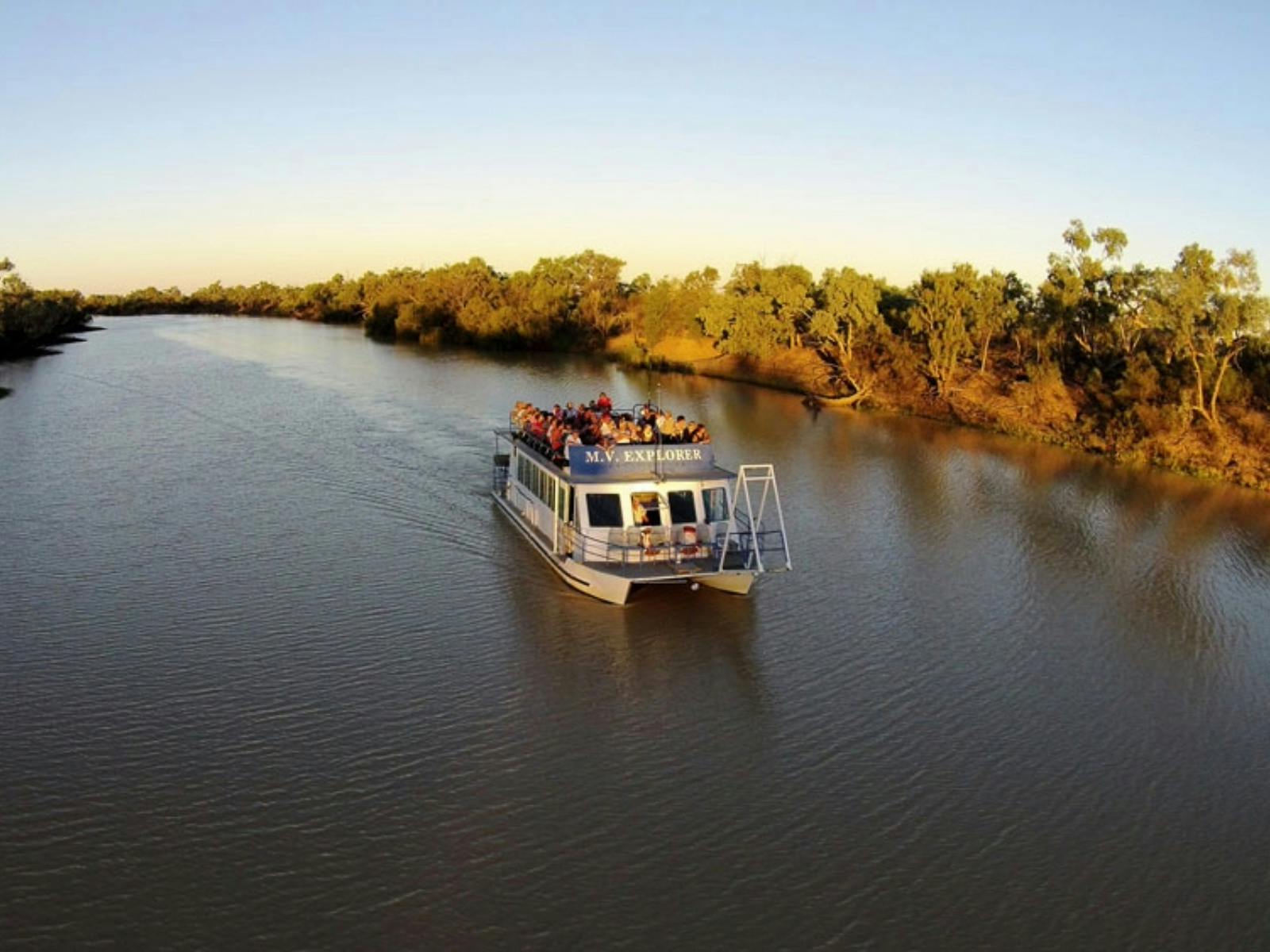 a blue and white catamaran in the middle of the river