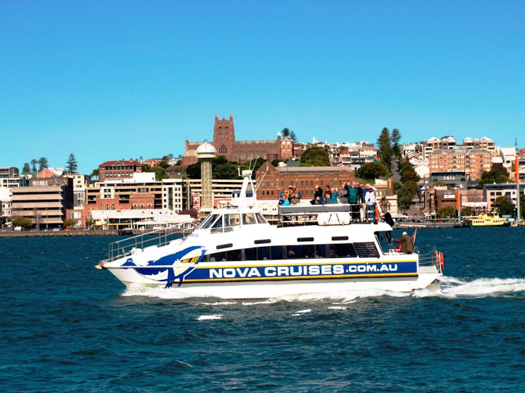 Side shot of vessel 'Bay Connections' cruising with Newcastle in background