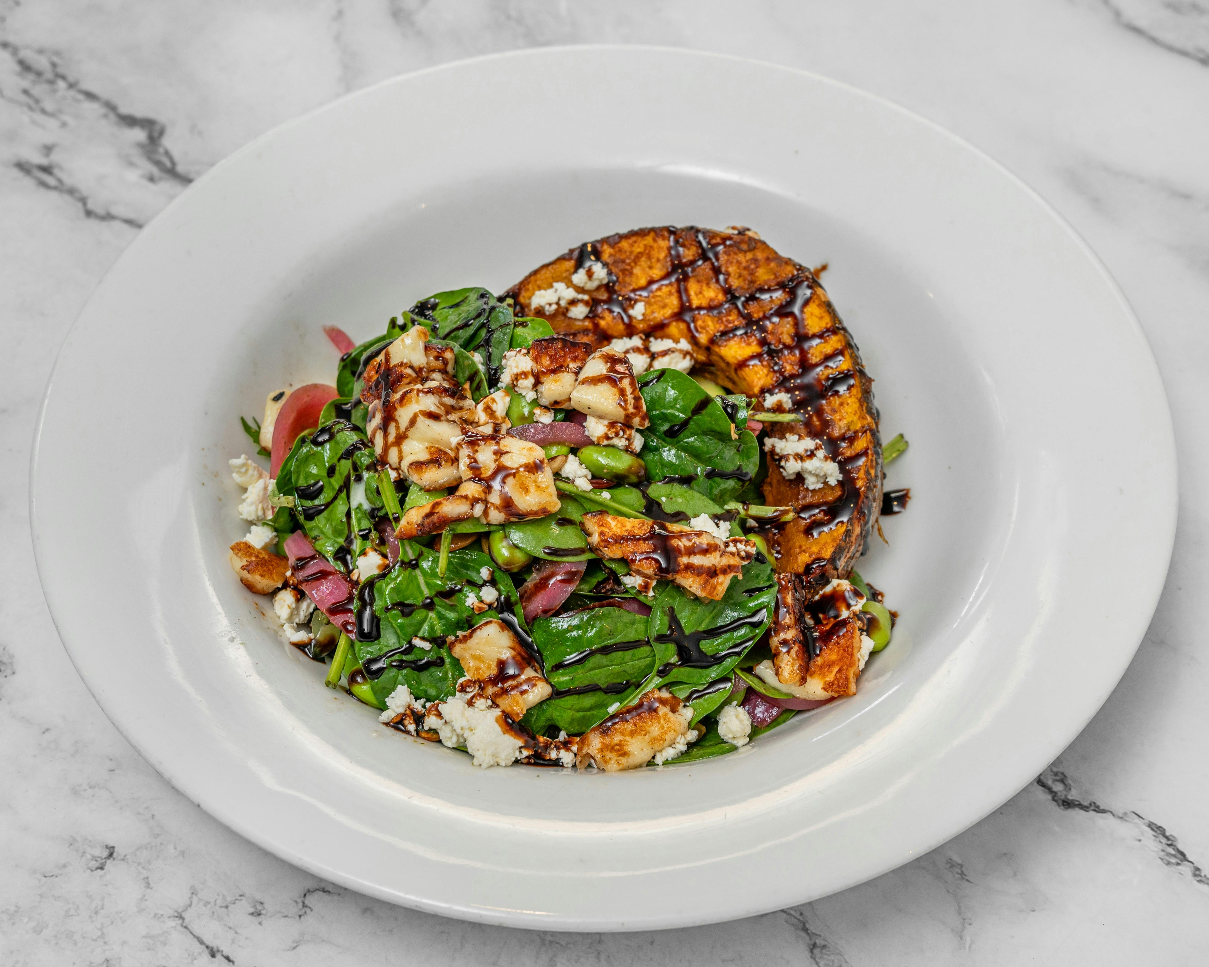 Spinach, roasted papitas, pesto dressing, grilled haloumi, pickled onion, edamame, balsamic glaze