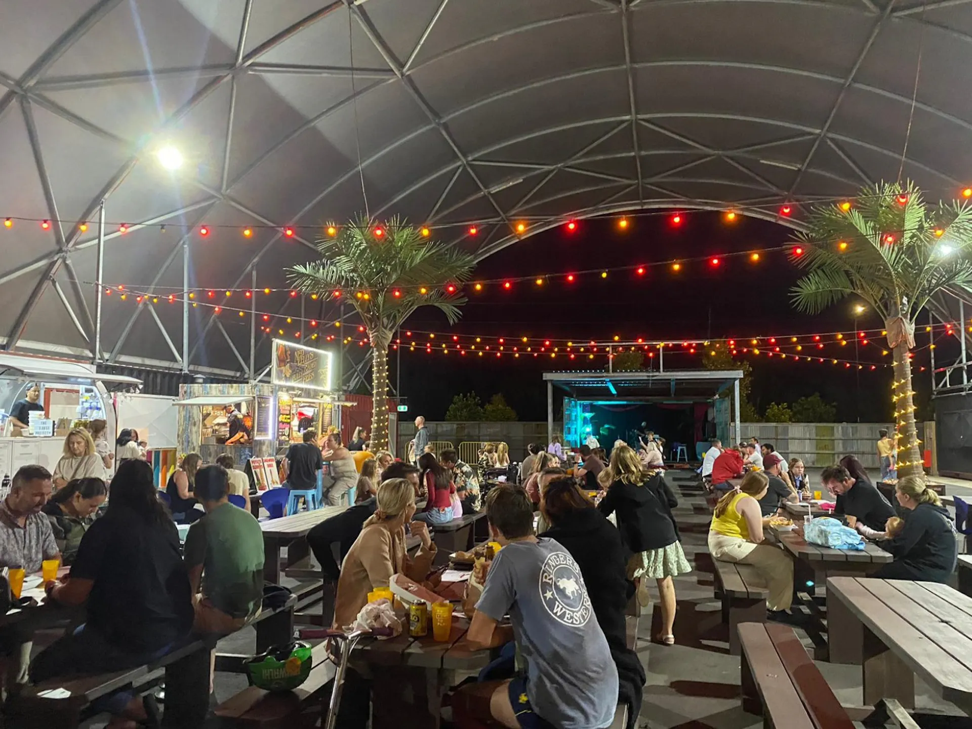 A image of lots of people seated at tables playing Beats Bingo