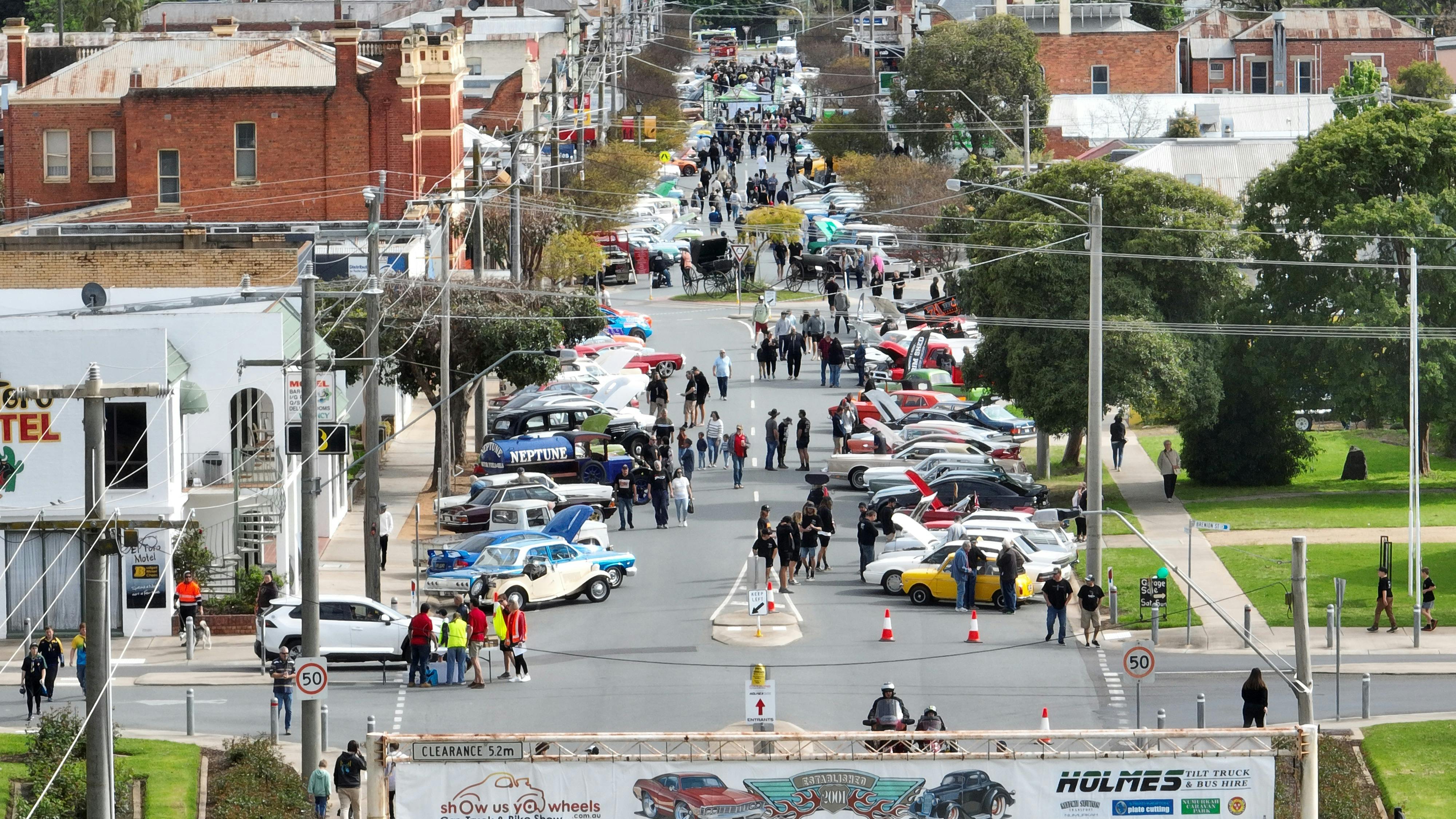 Photo of the main street filled with cars and people