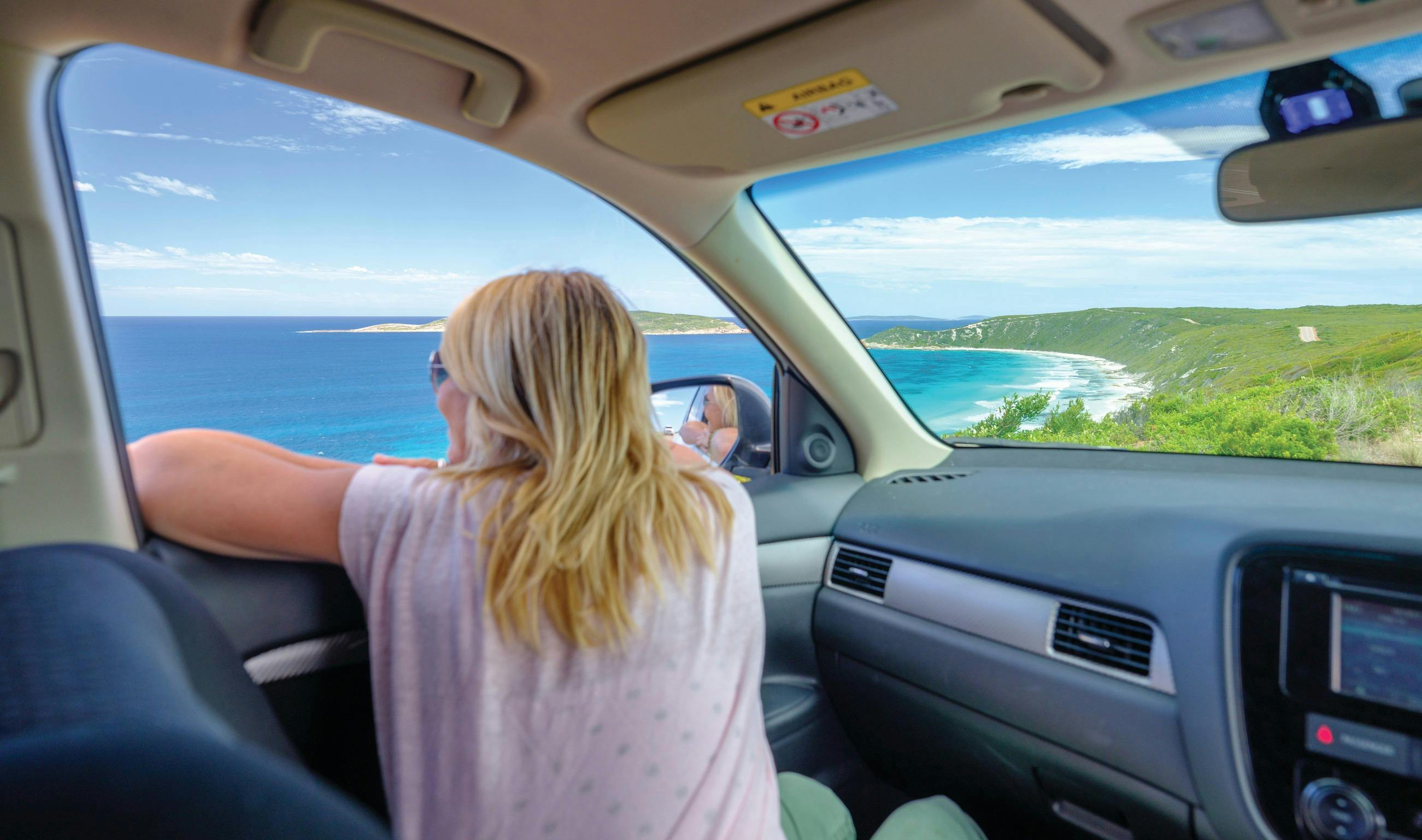 Couple driving along the Great Ocean Drive, Esperance