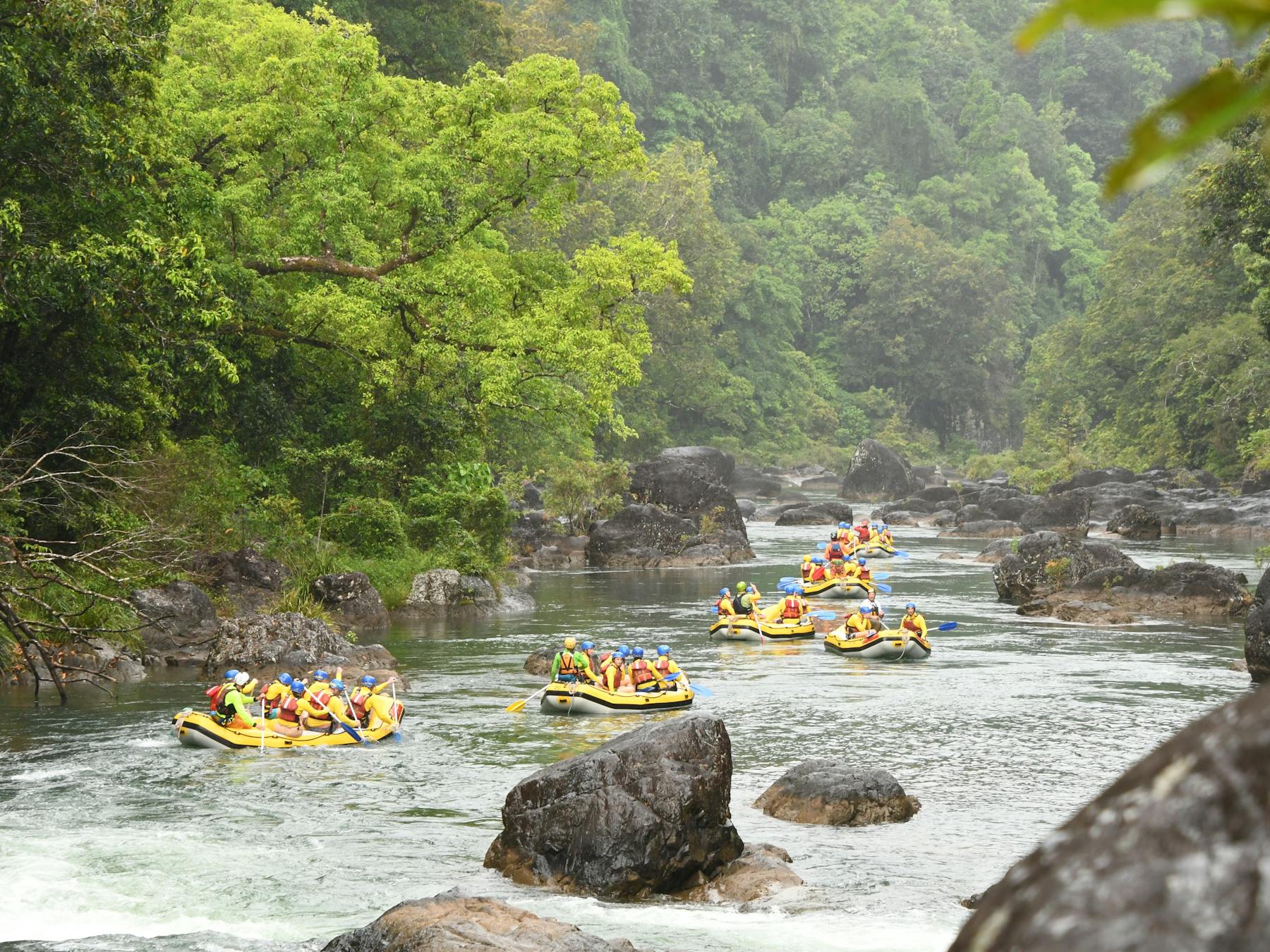 Scenic Shot of multiple rafts going down the Tully river in Tropical North Queensland