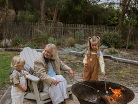 Children roasting marshmallows over outdoor fire pit at Tea Tree Retreat Robe South Australia