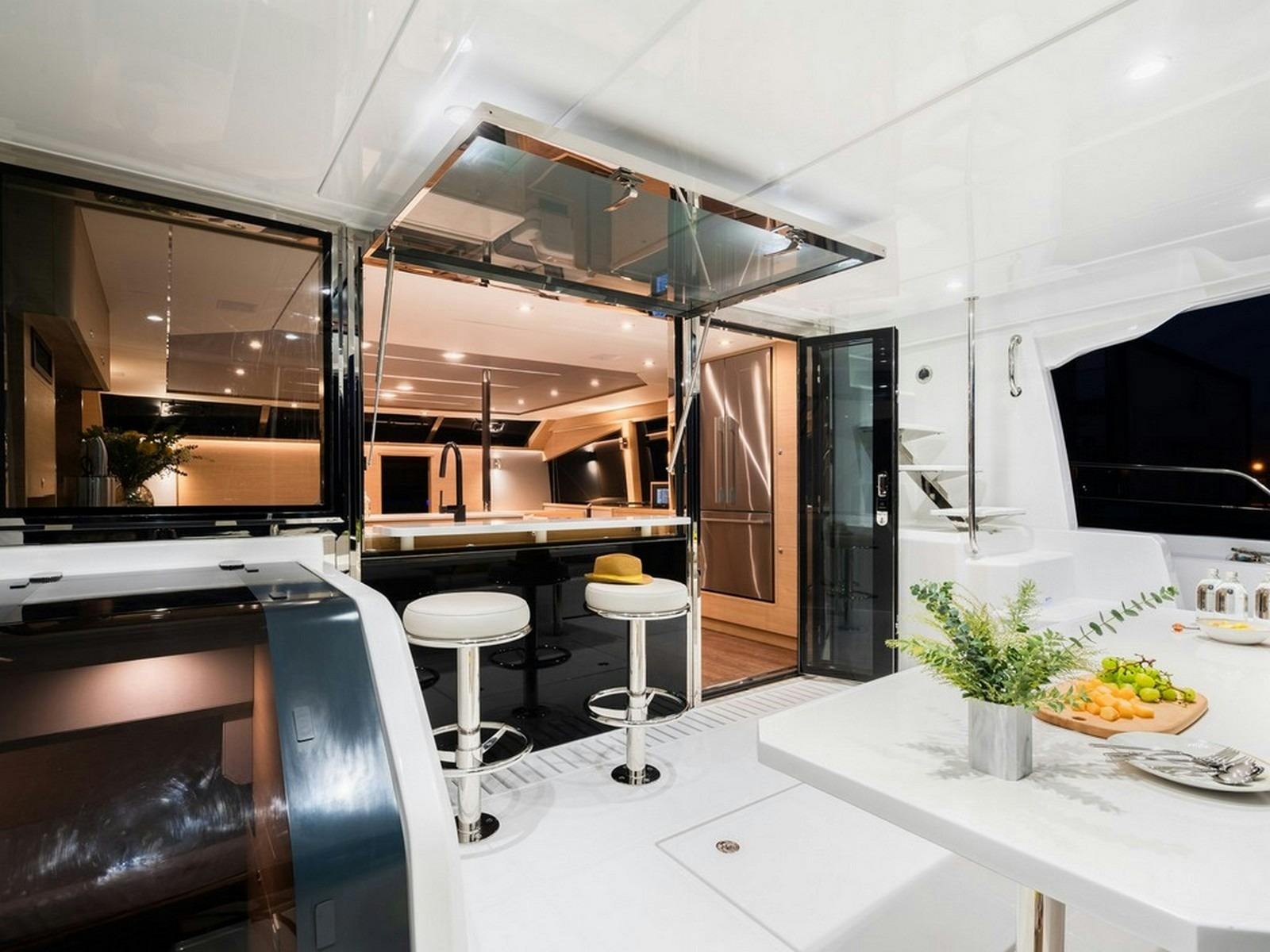 Aquila 54 - Aft deck dining with breakfast/cocktail bar and saloon access
