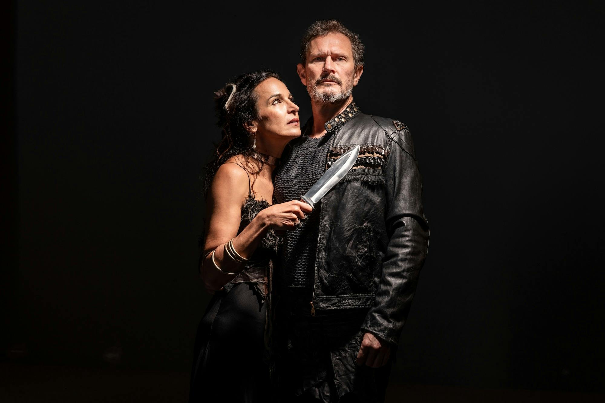Macbeth and Lady Macbeth against a dark background