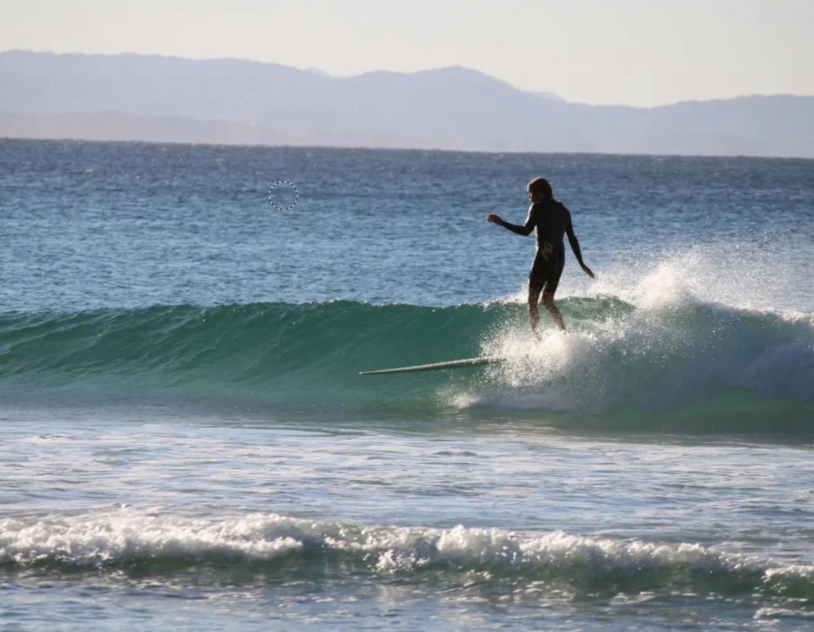 longboarder on nice wave