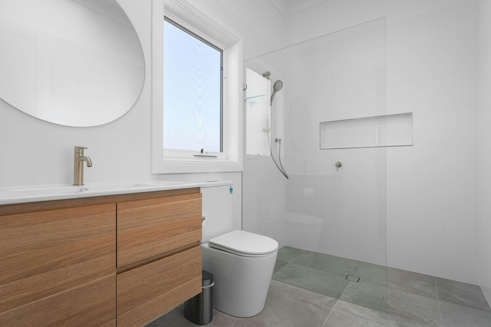 Open shower, toilet, and vanity