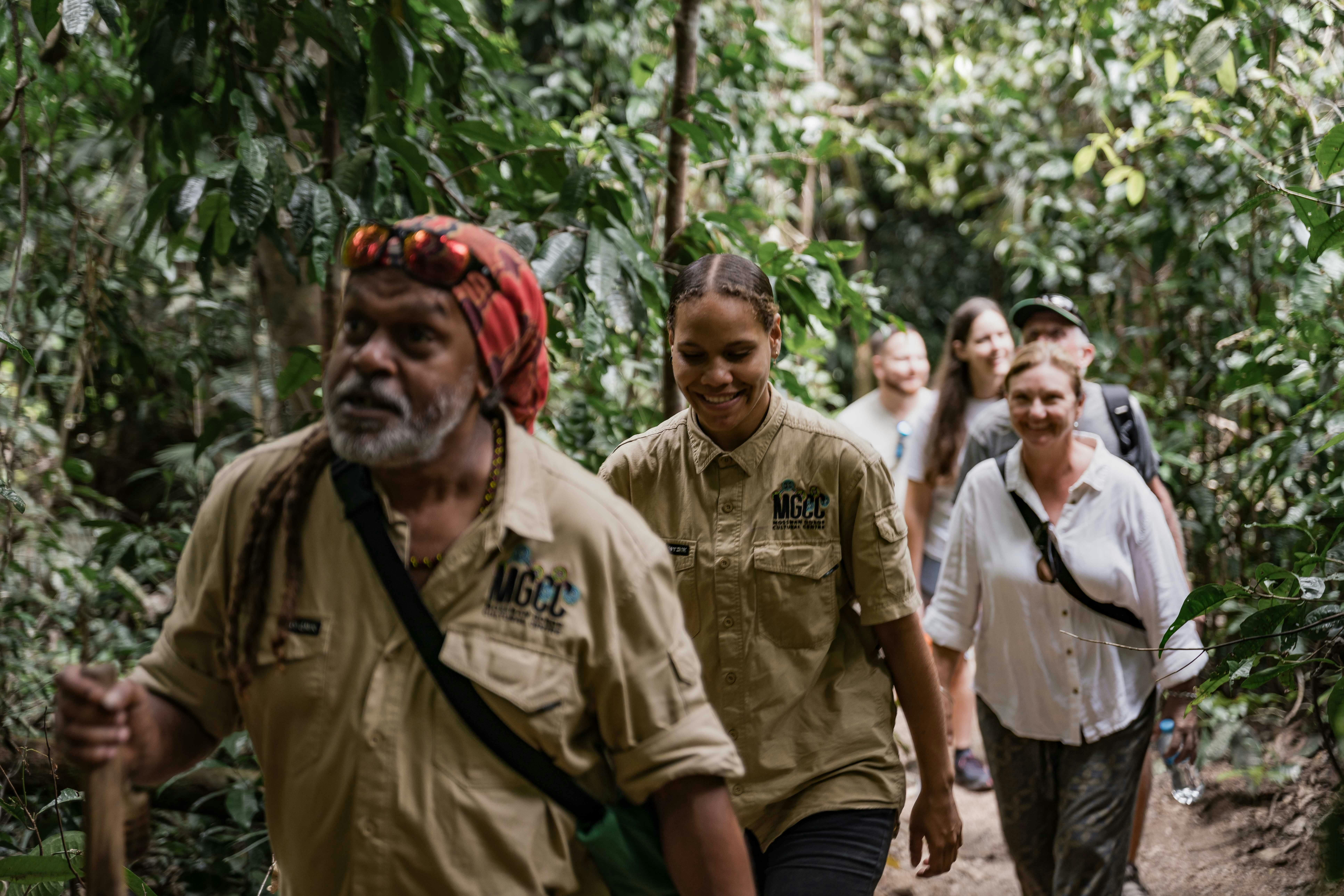 Two tour guides lead a group through Mossman Gorge during the Dreamtime Walk