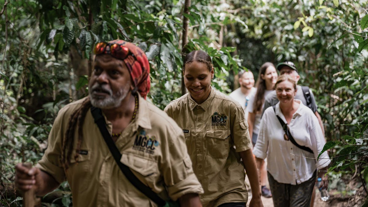 Two tour guides lead a group through Mossman Gorge during the Dreamtime Walk