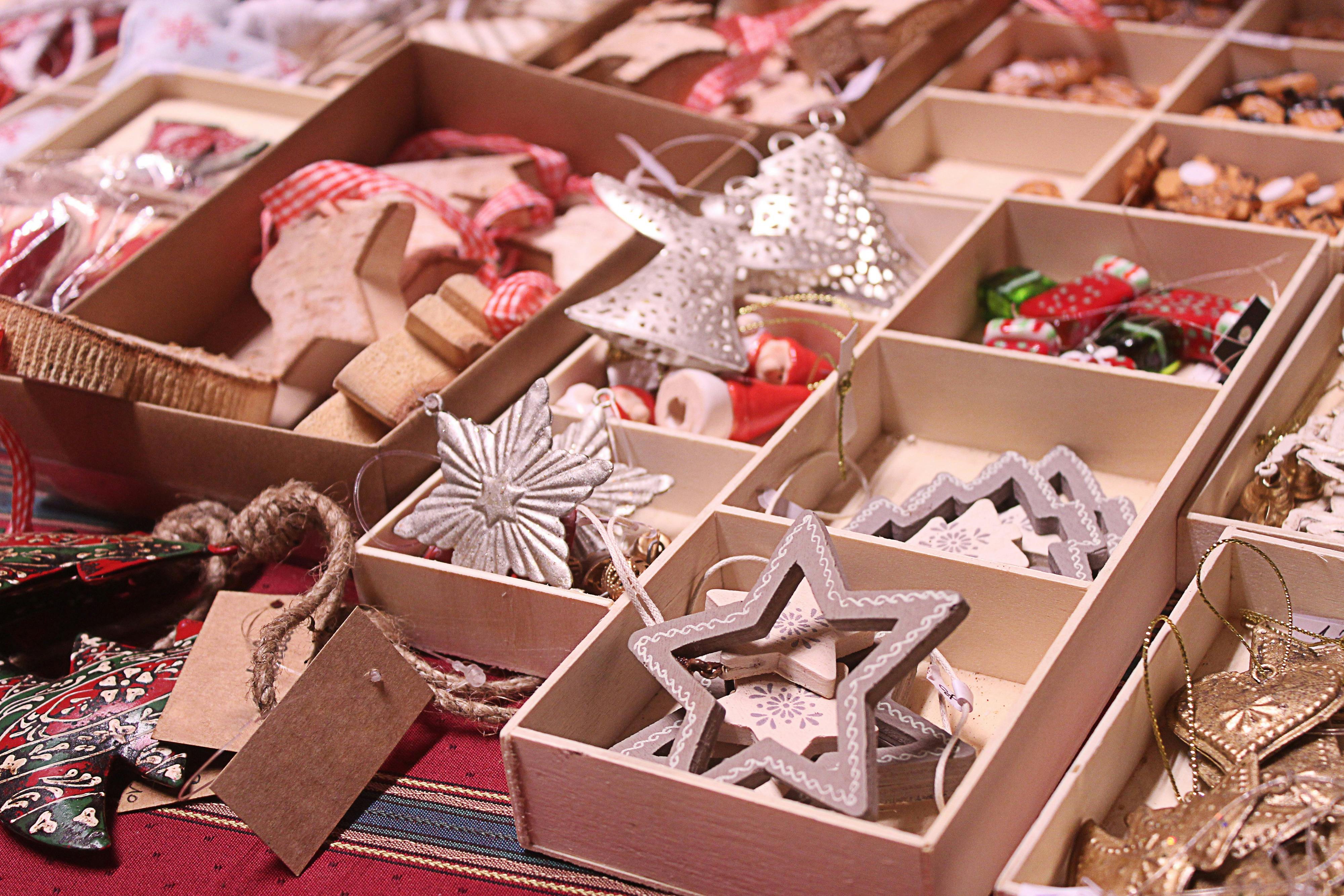 Christmas ornaments in open boxes sitting on a table an a market