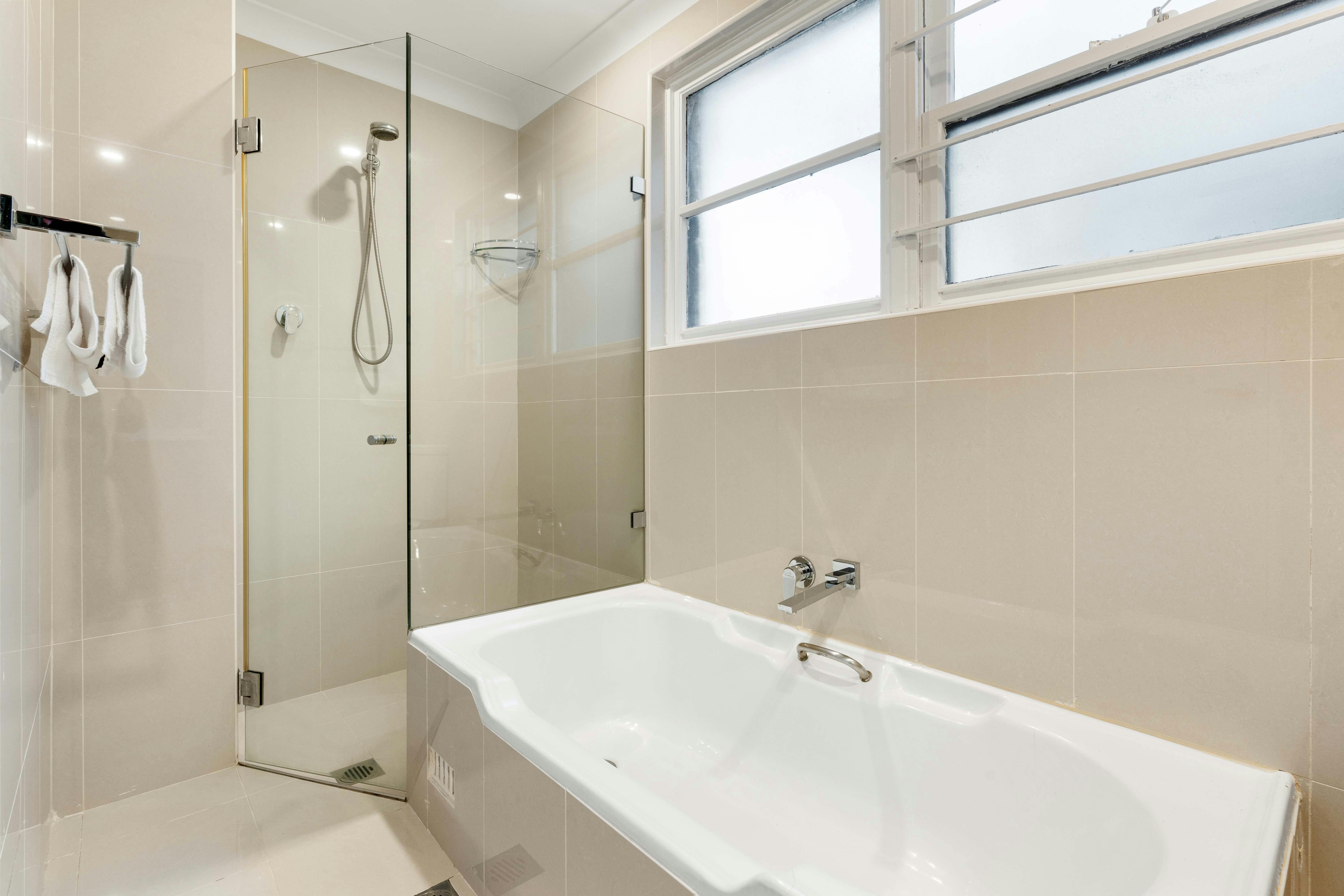 Shower space with glass partition and a clean, contemporary design.