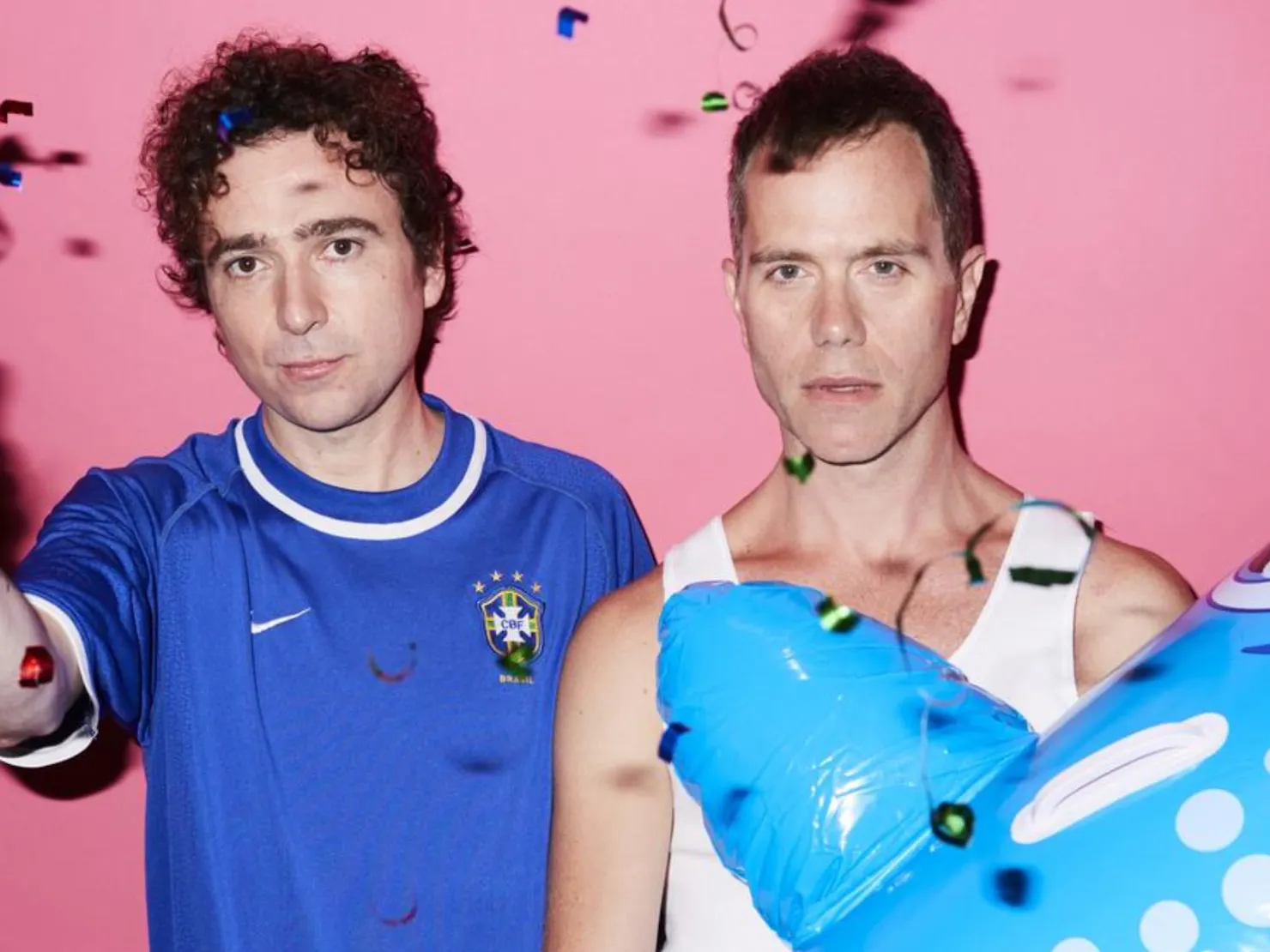Both band members against a pink wall