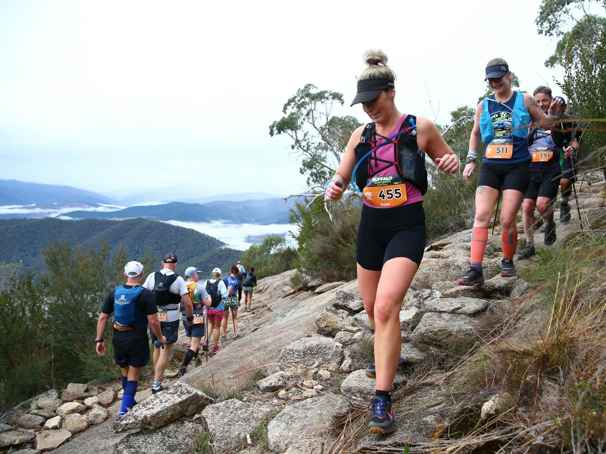 Group of people running on mountain.