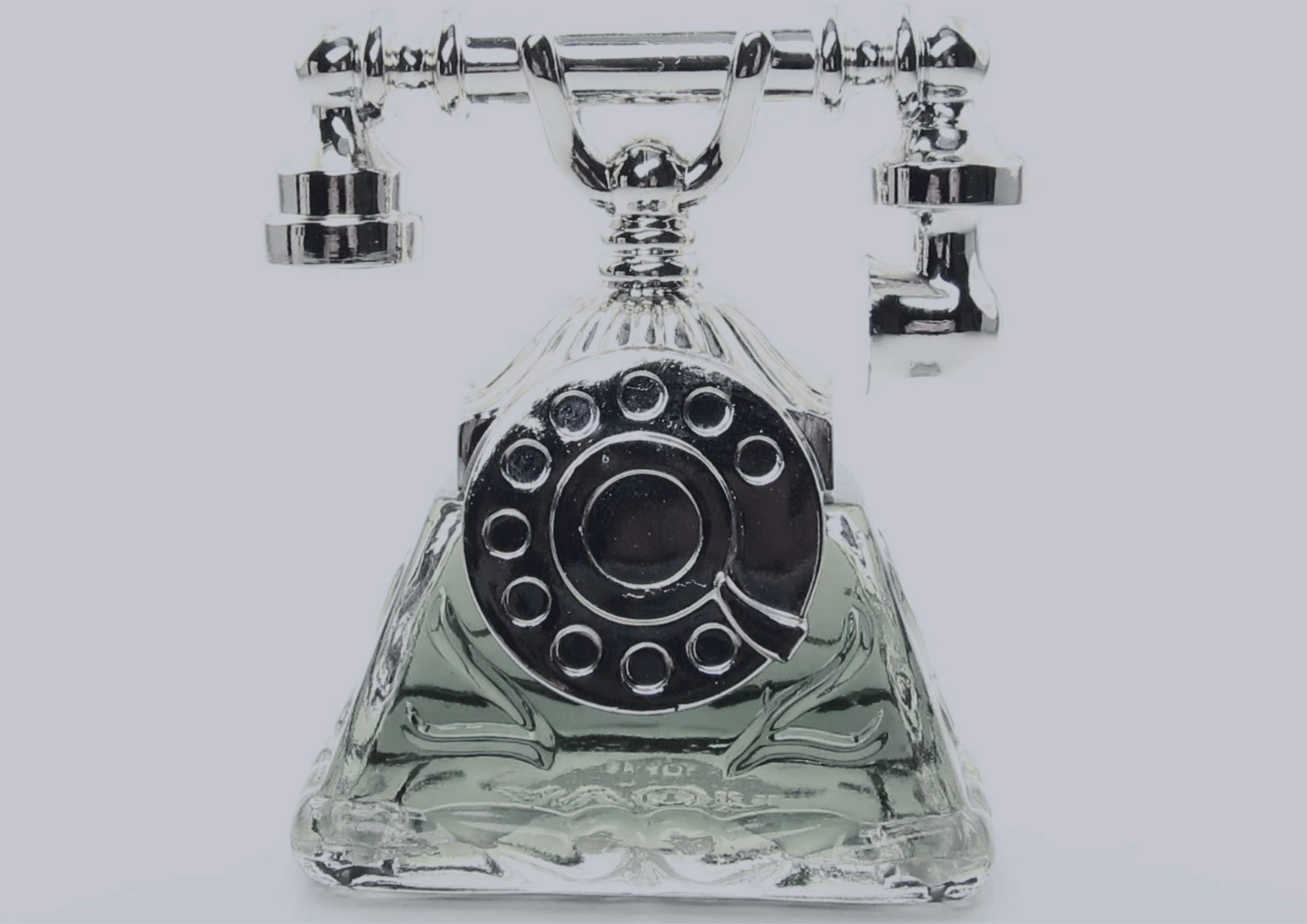 A photo of a telephone-shaped perfume bottle